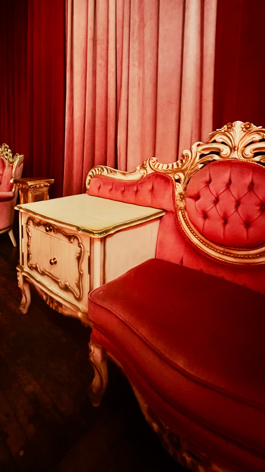 Vintage red tufted chaise lounge with gold trim